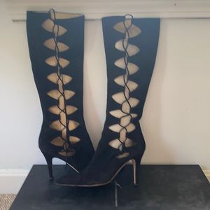 Black designer boots with lace-up cut out sides.